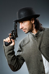 Man with gun and vintage hat