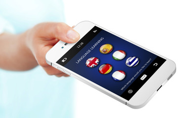 hand holding mobile phone with language learning application ove