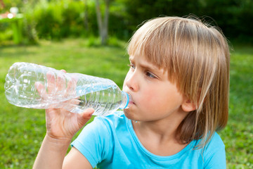 Child drinking water outdoor