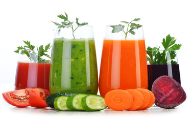 Glasses with fresh vegetable juices isolated on white