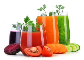 Glasses with fresh vegetable juices isolated on white