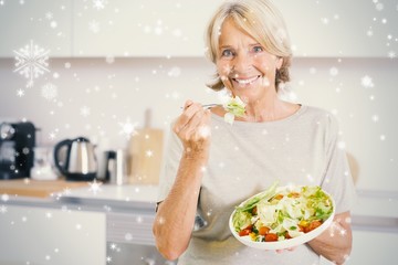 Composite image of smiling woman eating salad