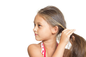 little girl doing hairstyle on a white background