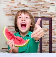 Little boy eating an watermelon