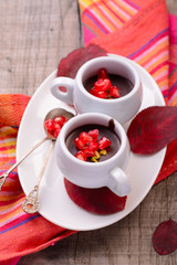 chocolate cream with pomegranate seeds on a wooden table