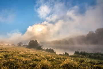 Foggy morning on the river - clouds skyes and grass - 70726175