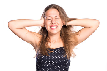 Fototapeta premium Young woman covering her ears on white isolated background