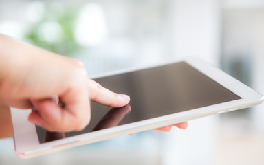 Woman hand hold white tablet with blank empty screen