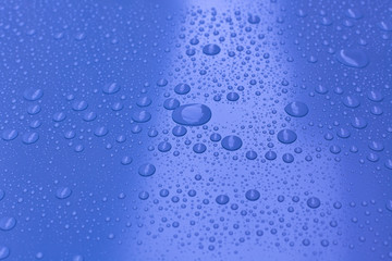 Water drops on bright blue background
