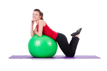 Young woman exercising with swiss ball