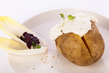Baked jacket potato with sour cream sauce