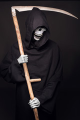Grim reaper. Studio portrait on black background