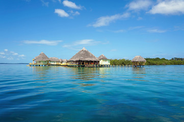 Tropical resort overwater with thatched roofs