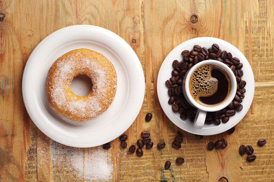 Sweet donut and cup of coffee
