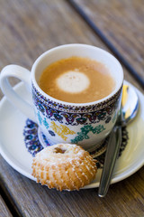 Cup of freshly brewed coffee and a cookie