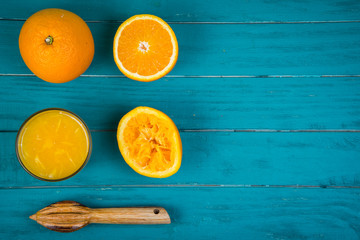 Making fresh organic oranges squeezed juice on table