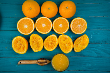 Making fresh organic oranges squeezed juice on table