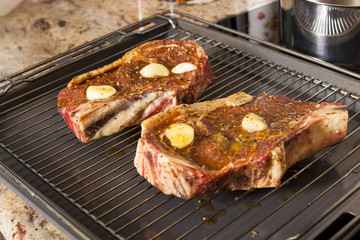 Two Steaks Marinated with Oil and Garlic on Grill