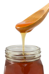 Close-up shot of flowing honey on white background