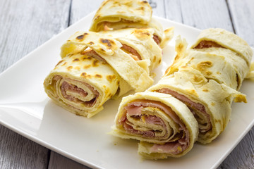 Roll of piadina with ham and cheese