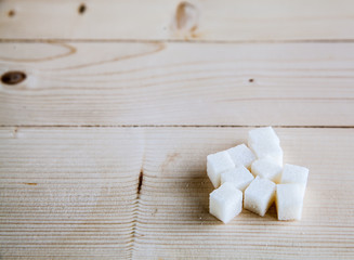 White sugar on wooden background