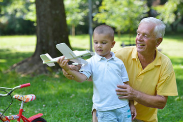 happy grandfather and child in park