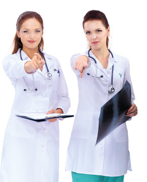 Two woman  nurse watching X Ray image and pointing to you ,