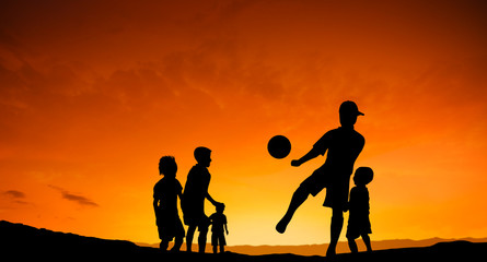 Five children playing soccer - football