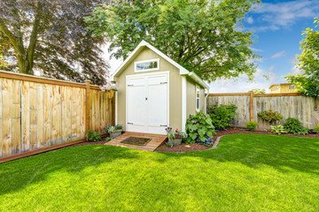 Fenced backyard with small shed - obrazy, fototapety, plakaty