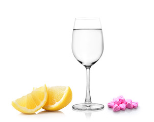 lemon glass of water and pills isolated on white background