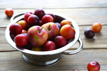 Fresh plums in a colander