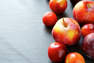 ripe fresh plums on a stone plate