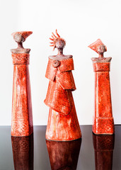 Three red african female figurines