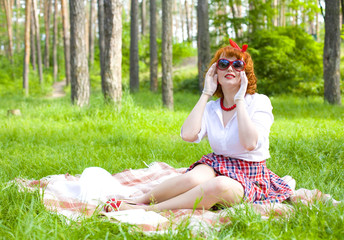 Portrait of pin-up girl in a summer forest