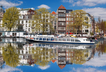 Amsterdam city with boats on canal in Holland