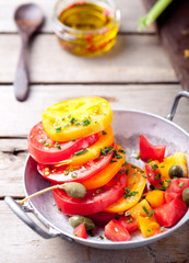 Red and yellow fresh tomato salad with bread