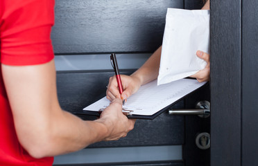 Woman signing package delivery papers