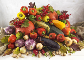 Stack of various vegetables with berries and nuts