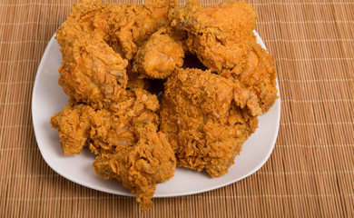 White Plate of Fried Chicken on Bamboo Placemat