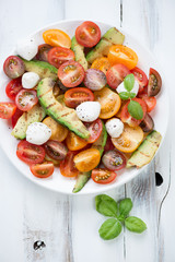 Vegetable salad with grilled avocado and mozzarella, above view