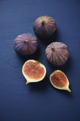 Close-up of whole and sliced fig fruits, view from above