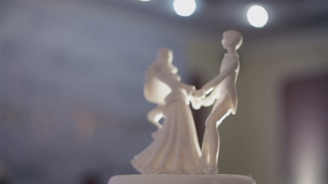 Closeup of wedding cake top bride and groom figurines