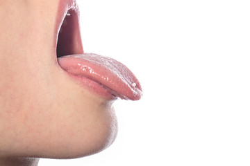 woman with a homeopathic globules on the tip of her tongue, isol