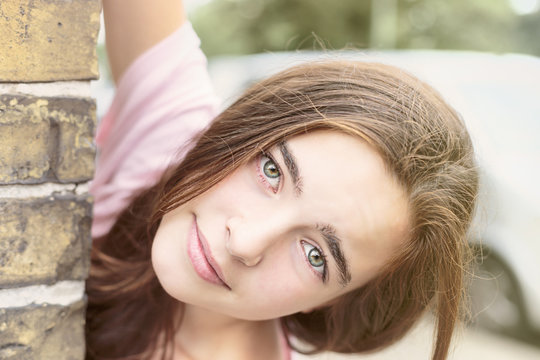 Portrait Of A Woman Looking Around The Corner