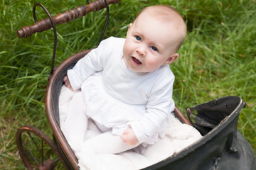 Baby is looking up in her pram