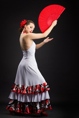 Young spanish woman dancing flamenco on black - obrazy, fototapety, plakaty