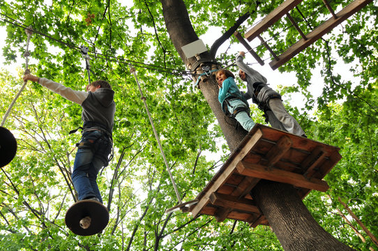 Children Enjoying In A Climbing Adventure Activity Park