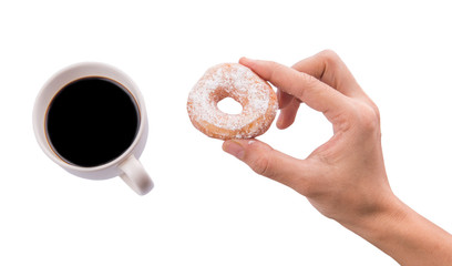 Female hand holding doughnuts with a mug of coffee