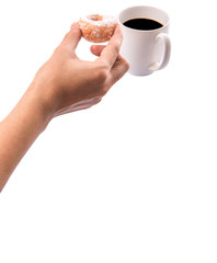 Female hand holding doughnuts with a mug of coffee