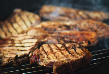 Grilled steaks on barbecue